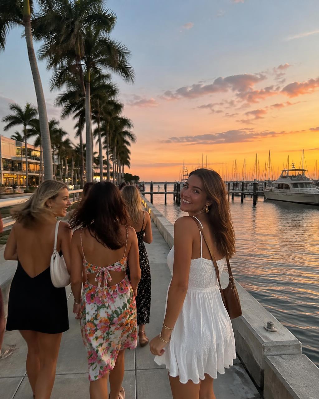 Friends strolling the St. Pete waterfront at sunset
